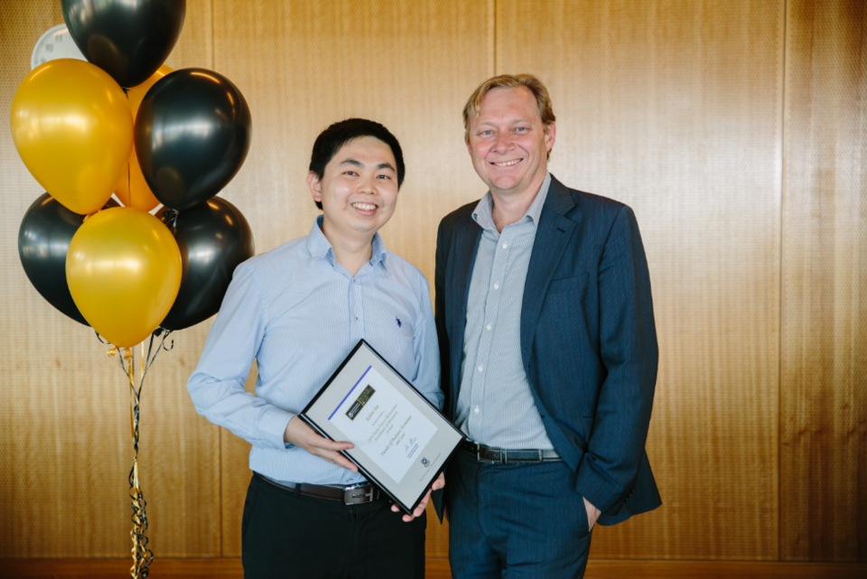 Kelvin Tan accepts award from BEL Executive Dean Professor Andrew Griffiths